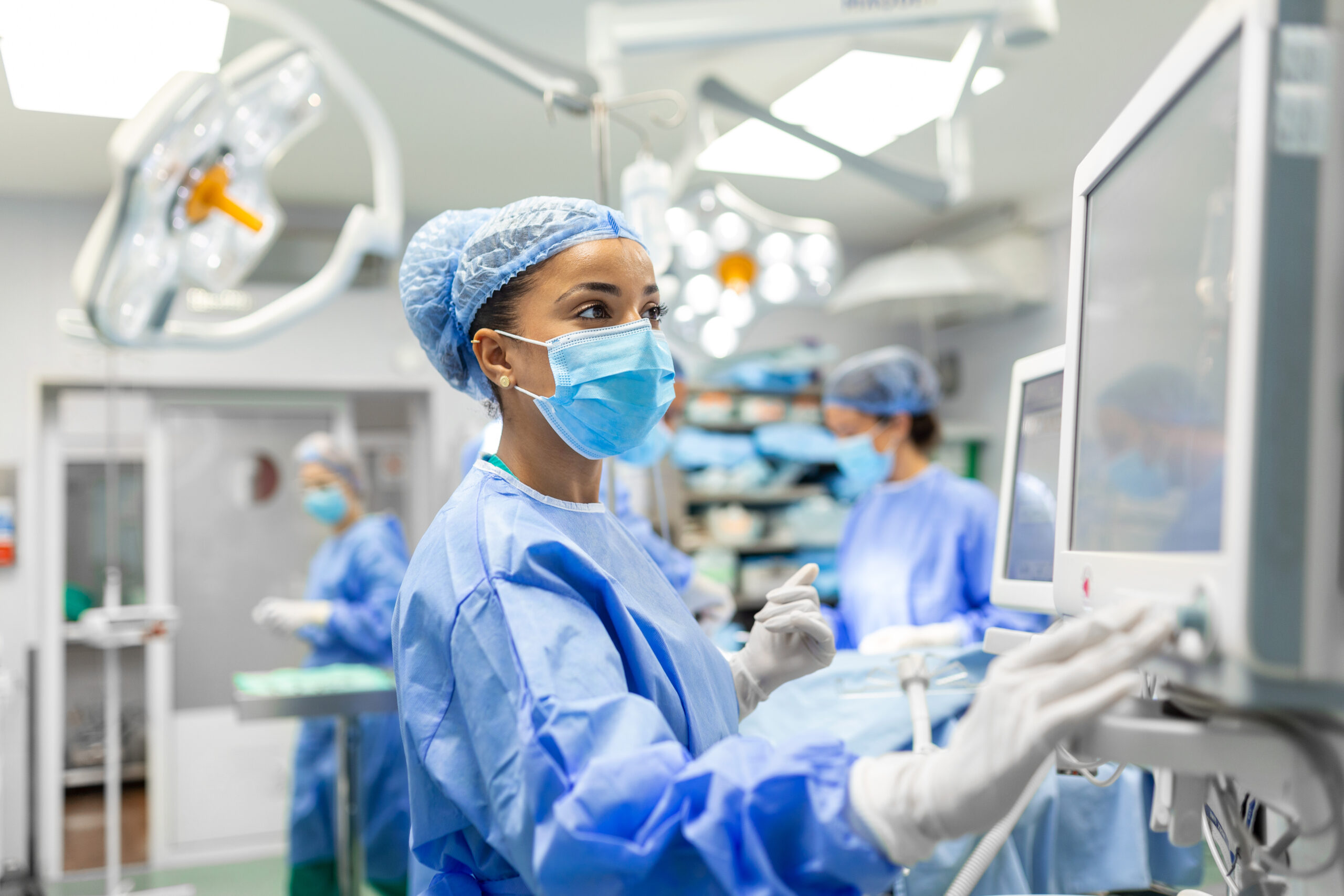 Operating room nurses, doctors, and crew getting ready for operation.